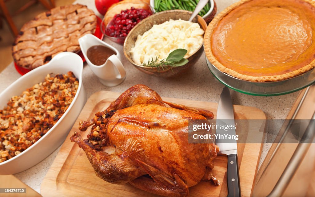 Thanksgiving Roast Turkey Dinner with Seasonal Holiday Foods in Kitchen