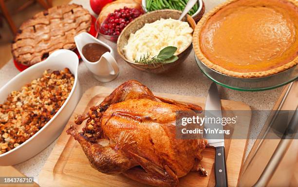 thanksgiving roast turkey dinner with seasonal holiday foods in kitchen - side dish stock pictures, royalty-free photos & images