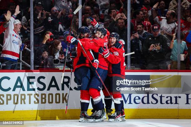 Tom Wilson of the Washington Capitals celebrates with Dylan Strome and Rasmus Sandin after scoring a goal against the New York Rangers during the...