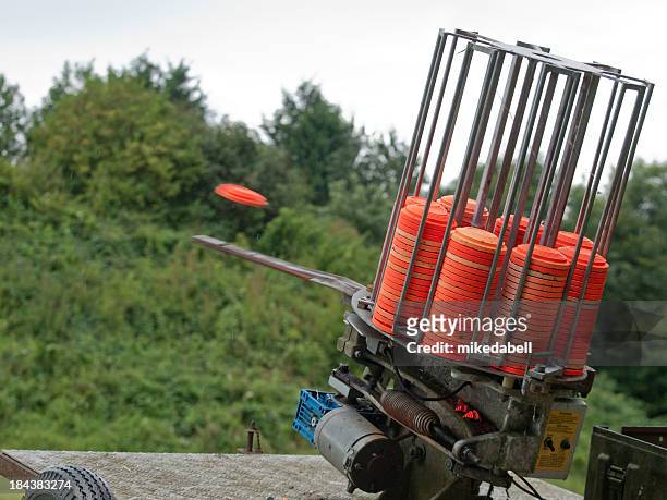 a clay pigeon is ejected out of a clay target machine - skeet shooting stock pictures, royalty-free photos & images
