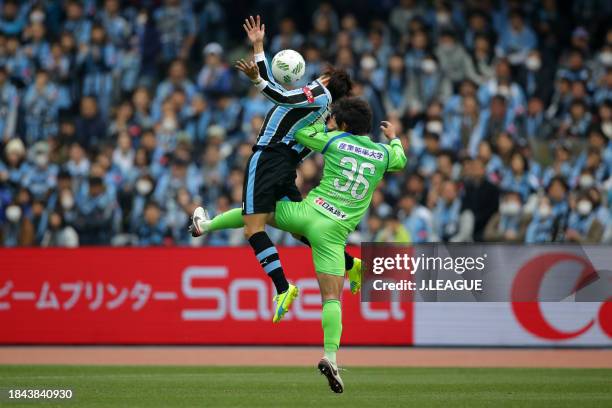 Yu Kobayashi of Kawasaki Frontale controls the ball against Takuya Okamoto of Shonan Bellmare during the J.League J1 first stage match between...