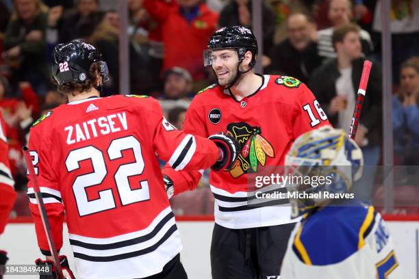 Jason Dickinson of the Chicago Blackhawks celebrates with Nikita Zaitsev after scoring a goal against the St. Louis Blues during the second period at...