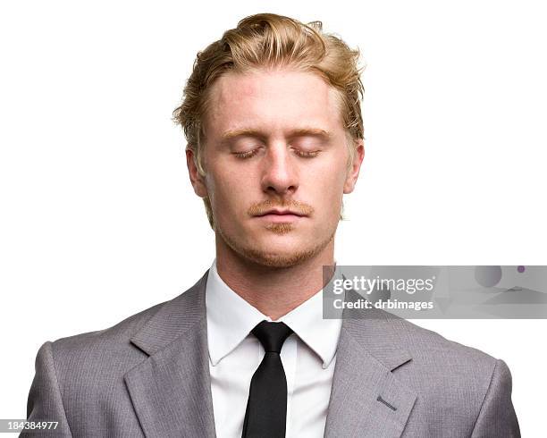 red haired male portrait with eyes closed - red suit stockfoto's en -beelden