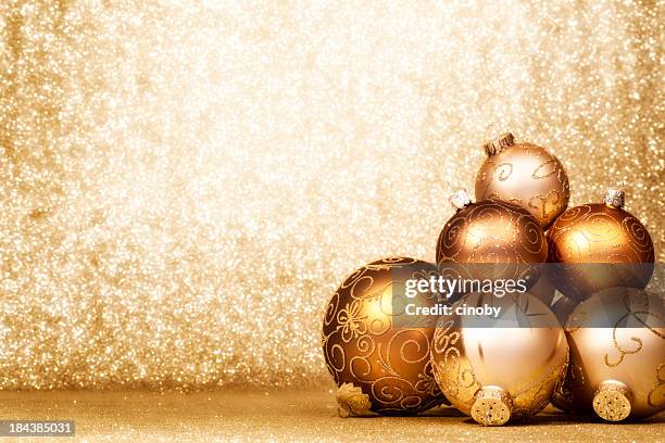 pile of golden christmas baubles - christmas gold background stock pictures, royalty-free photos & images