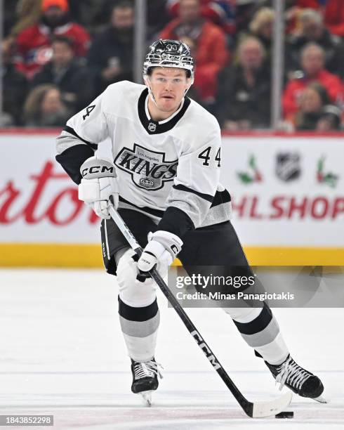 Mikey Anderson of the Los Angeles Kings skates the puck during the third period against the Montreal Canadiens at the Bell Centre on December 7, 2023...