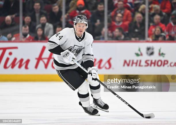 Mikey Anderson of the Los Angeles Kings skates the puck during the third period against the Montreal Canadiens at the Bell Centre on December 7, 2023...