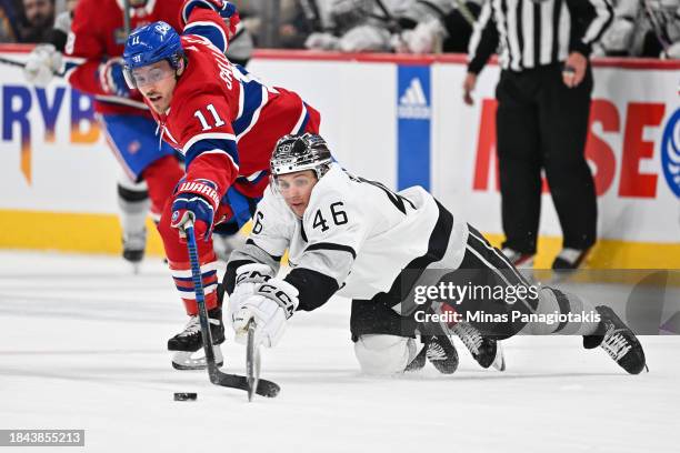 Blake Lizotte of the Los Angeles Kings skates the puck against Brendan Gallagher of the Montreal Canadiens during the third period at the Bell Centre...