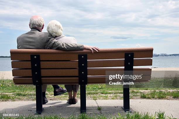 altes paar sitzt auf der parkbank - man on bench stock-fotos und bilder