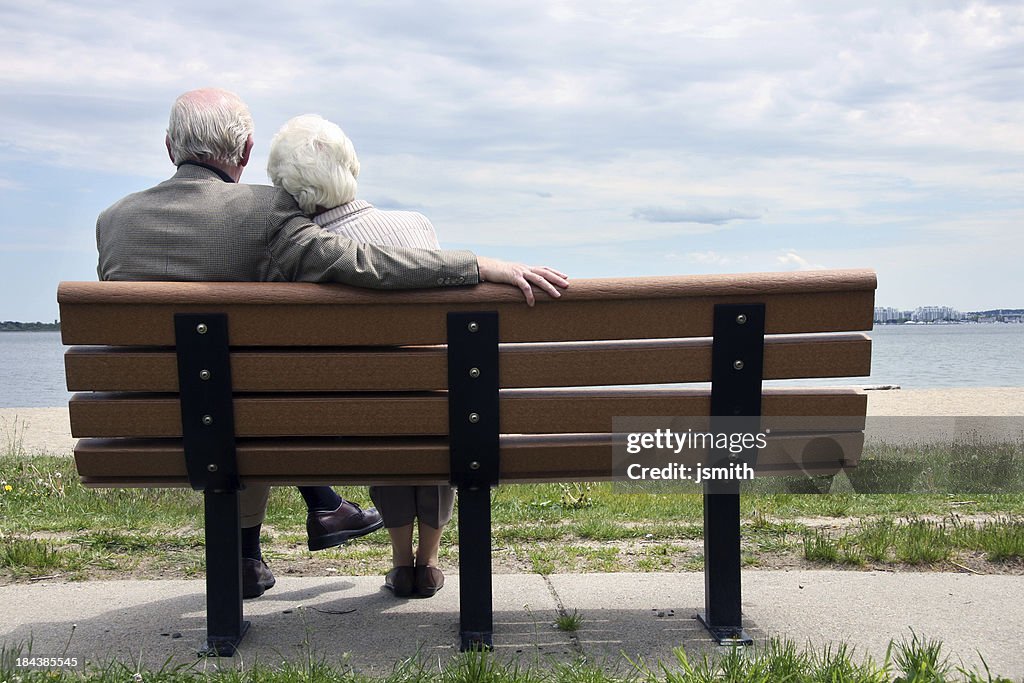 Senior Couple Sitting On The Park Bench