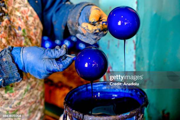 An employee make folkloric toys as a symbol of the New Year at 'Biryusinka' Toy Factory in Krasnoyarsk, Russia on December 08, 2023. The factory...