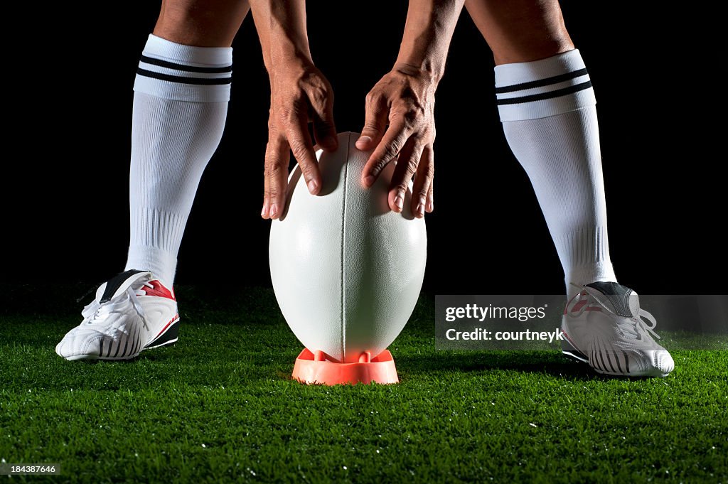 Close up of man getting ready to kick for goal