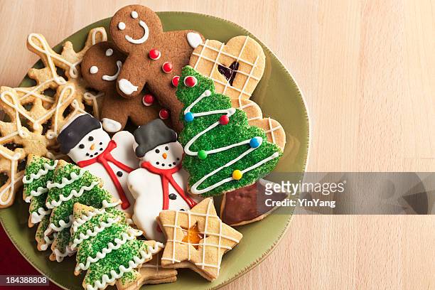christmas cookie holiday plate featuring tree, gingerbread, snowman, snowflake desserts - cookie stock pictures, royalty-free photos & images