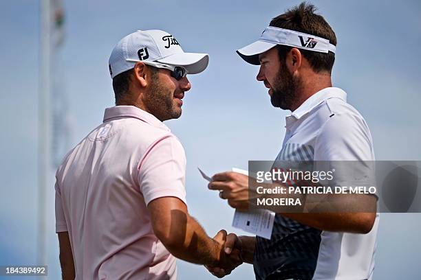 Scottish golfer Scott Jamieson greets British golfer Paul Waring at the 1st hole during the last day of the Portugal Masters golf tounament at...