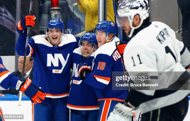 Noah Dobson, Jean-Gabariel Pageau and Simon Holmstrom of the New York Islanders celebrate Pageau's overtime goal against the Los Angeles Kings at UBS...