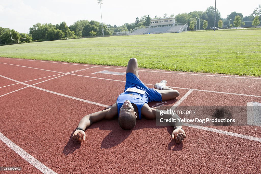 Tired runner Laying on Track after Race