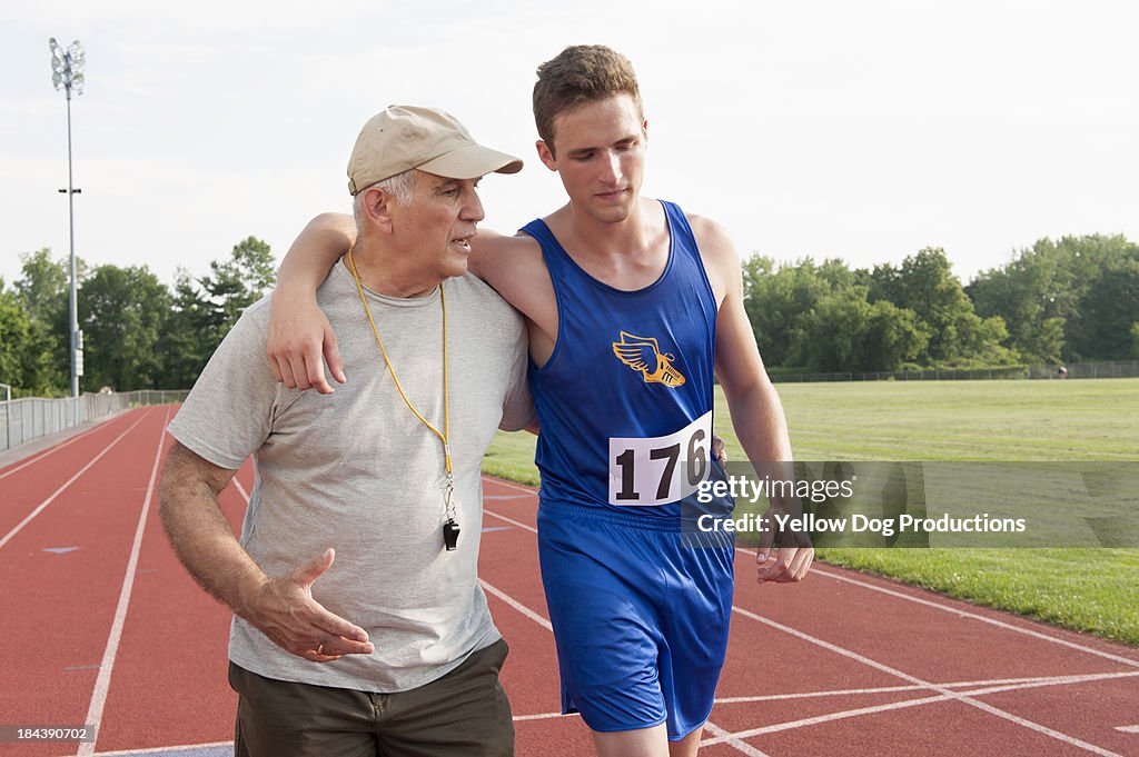 Coach helping runner after race