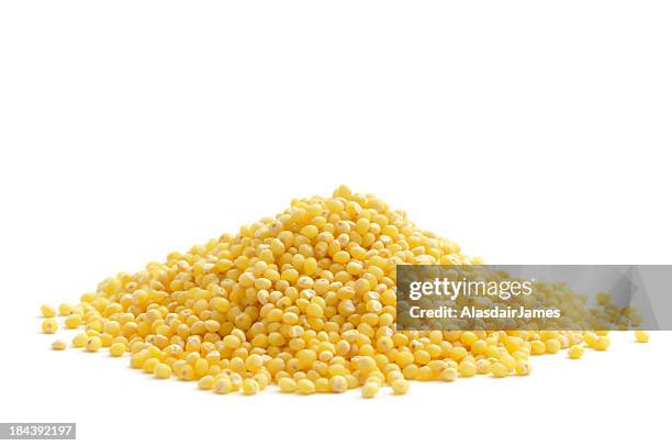 a pile of the food millet on a white background  - millet stock pictures, royalty-free photos & images