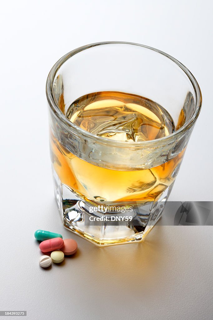 Alcohol and Prescription Medication On Light Gray Background