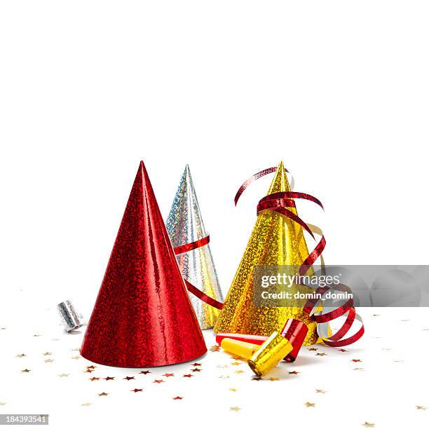 multicoloured party hats isolated on white background, studio shot - gold streamer stock pictures, royalty-free photos & images