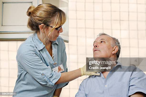 profissional da saúde verificação homem de garganta - speech therapy imagens e fotografias de stock