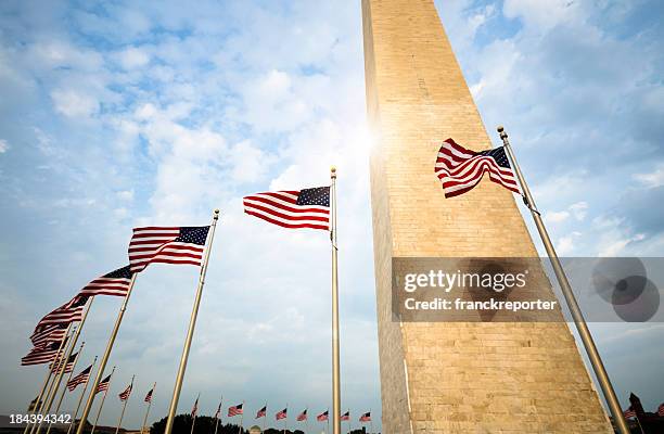 washington monument and us flag - washington dc monuments stock pictures, royalty-free photos & images