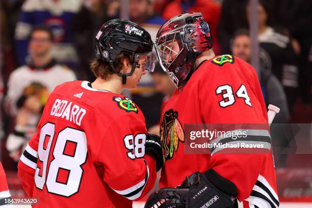 Connor Bedard and Petr Mrazek of the Chicago Blackhawks celebrate after defeating the St. Louis Blues 3-1 at the United Center on December 09, 2023...