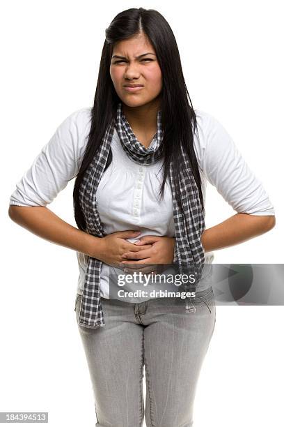 a photograph of a lady holding her stomach while grimacing - food borne illness stock pictures, royalty-free photos & images