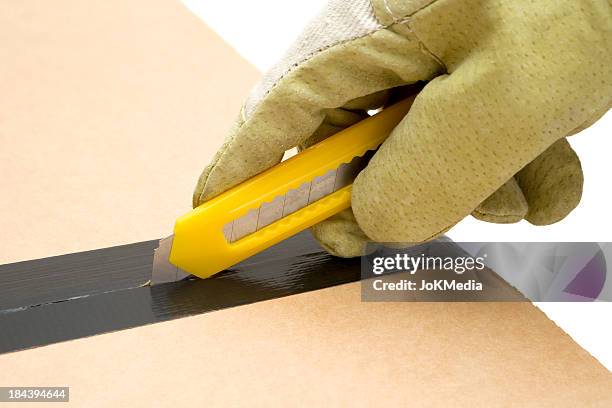 worker opening a cardboard box - blade stock pictures, royalty-free photos & images