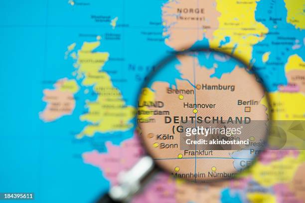 colorful map with magnifying glass over germany - german stock pictures, royalty-free photos & images