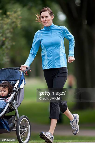 jogger and baby - three wheeled pushchair stock pictures, royalty-free photos & images