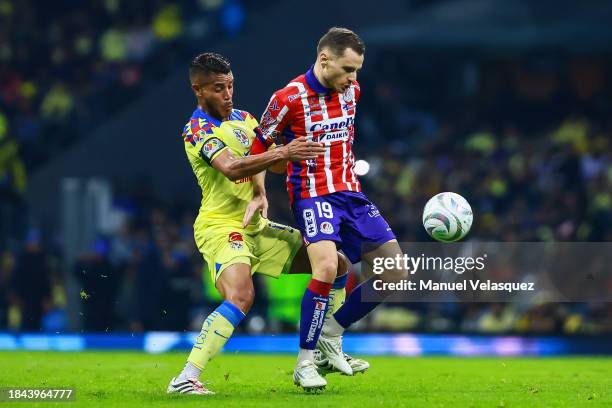 Jonathan Dos Santos of America struggles for the ball against Sebastien Salles-lamonge of Atletico San Luis during the semifinals second leg match...