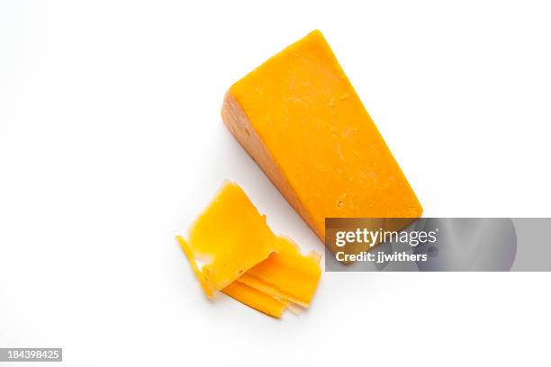 block and shavings of cheddar cheese - cheese cubes stock pictures, royalty-free photos & images