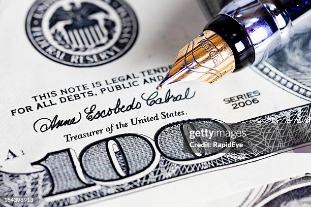 close up of fountain pen nib on $100 bill - counterfeit money stock pictures, royalty-free photos & images