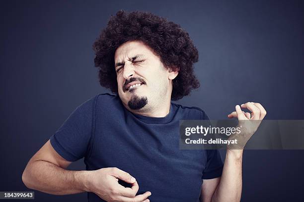 man with moustache intensely plays air guitar - air guitar stock pictures, royalty-free photos & images