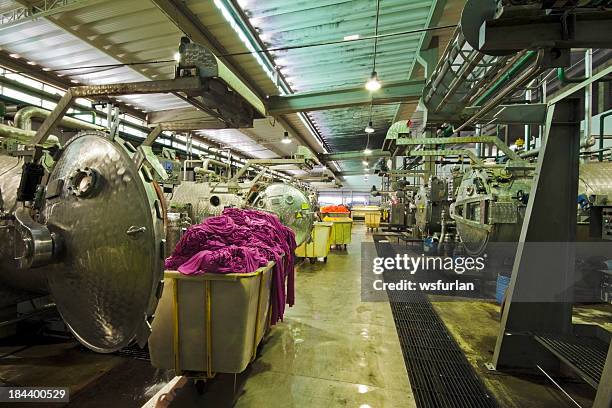 industrial laundry room with washers and laundry piles - textile machine stock pictures, royalty-free photos & images