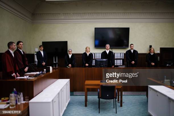 The presiding judge Detlev Schmidt and colleagues and prosecutors Lars Malskies and Cai Rueffer stand inside the courtroom prior to the beginning of...