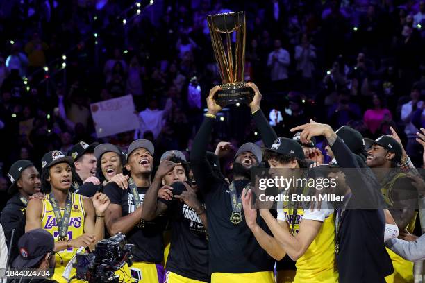 LeBron James of the Los Angeles Lakers hoists the trophy with his teammates after winning the championship game of the inaugural NBA In-Season...