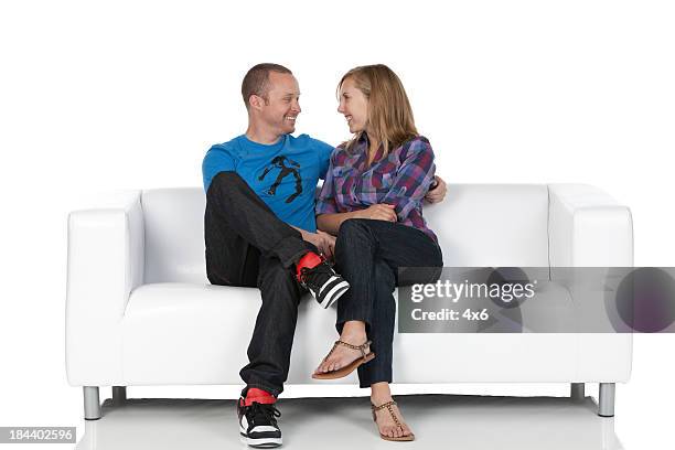 romantisches paar sitzt auf einer couch - romantic couple on white background stock-fotos und bilder