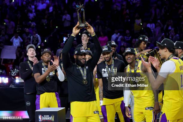 LeBron James of the Los Angeles Lakers hoists the MVP trophy after winning the championship game of the inaugural NBA In-Season Tournament at...