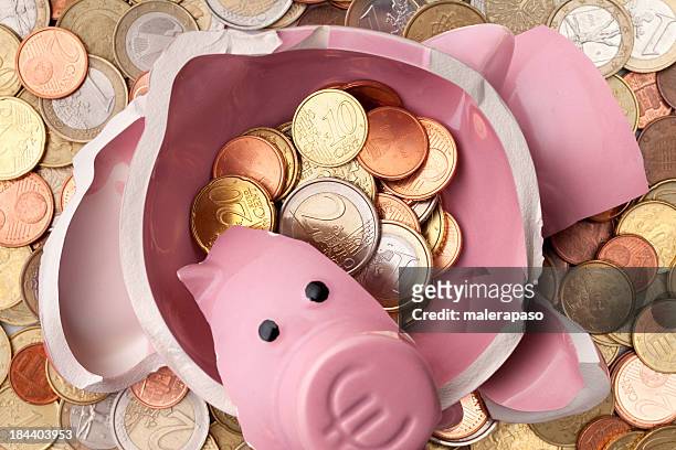 savings. broken piggy bank with euro coins - euro dollar stock pictures, royalty-free photos & images