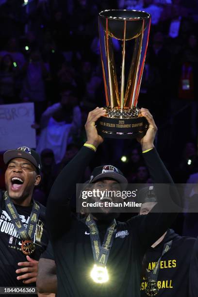 LeBron James of the Los Angeles Lakers hoists the trophy with his teammates after winning the championship game of the inaugural NBA In-Season...