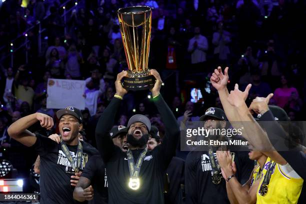 LeBron James of the Los Angeles Lakers hoists the trophy with his teammates after winning the championship game of the inaugural NBA In-Season...