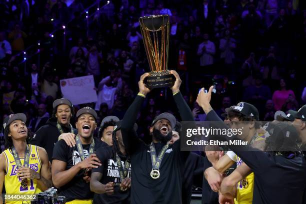 LeBron James of the Los Angeles Lakers hoists the trophy with his teammates after winning the championship game of the inaugural NBA In-Season...