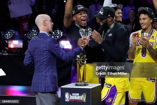 Commissioner Adam Silver presents the MVP trophy to LeBron James of the Los Angeles Lakers as Rui Hachimura reacts after the Lakers defeated the...