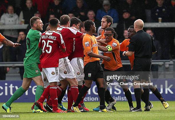 Refereee Nick Kinseley steps in as players square up after Barnet player manager Edgar Davids elbowed Steven Wright of Wrexham in the face during the...