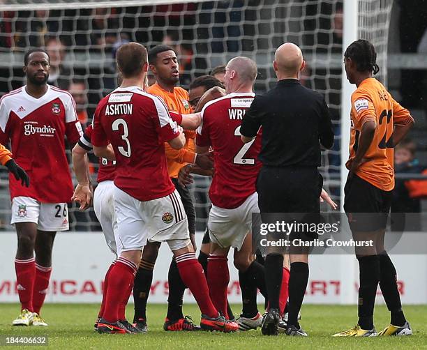 Barnet player manager Edgar Davids elbows Stephen Wright of Wrexham in the face, watched by referee Nick Kinseley during the Skrill Conference...