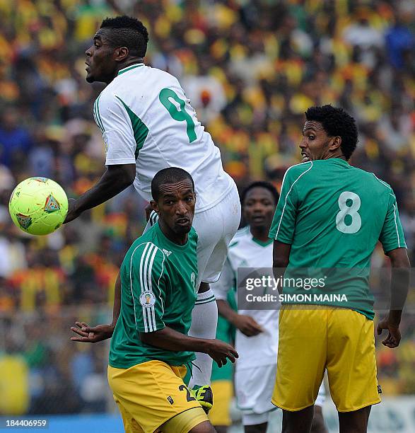 Nigeria's Emmanuel Emenike reaches for the ball in front of Ethiopia's Degu Debebe and teammate Asrat Mebersa on October 13, 2013 during a 2014 World...