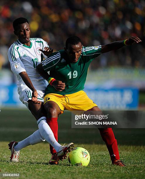 Nigeria Super Eagle center Ogu John fights for the ball with Ethiopian forward Adane Girma on October 13, 2013 during a 2014 World Cup Qualifier...