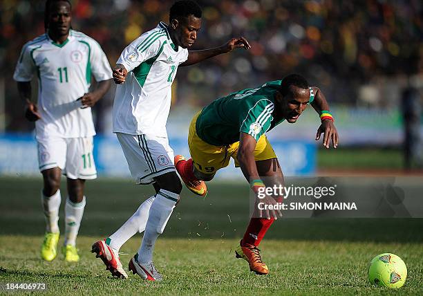 Nigeria's Ogu John fights for the ball with Ethiopia's Adane Girma on October 13, 2013 during a 2014 World Cup qualifying match in Addis Ababa. AFP...