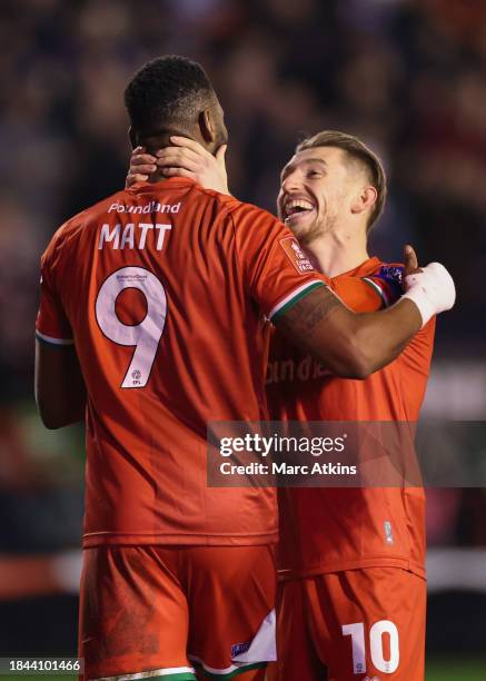 Jamille Matt of Walsall celebrates scoring the opening goal with Tom Knowles during the Emirates FA Cup Second Round Replay match between Walsall and...